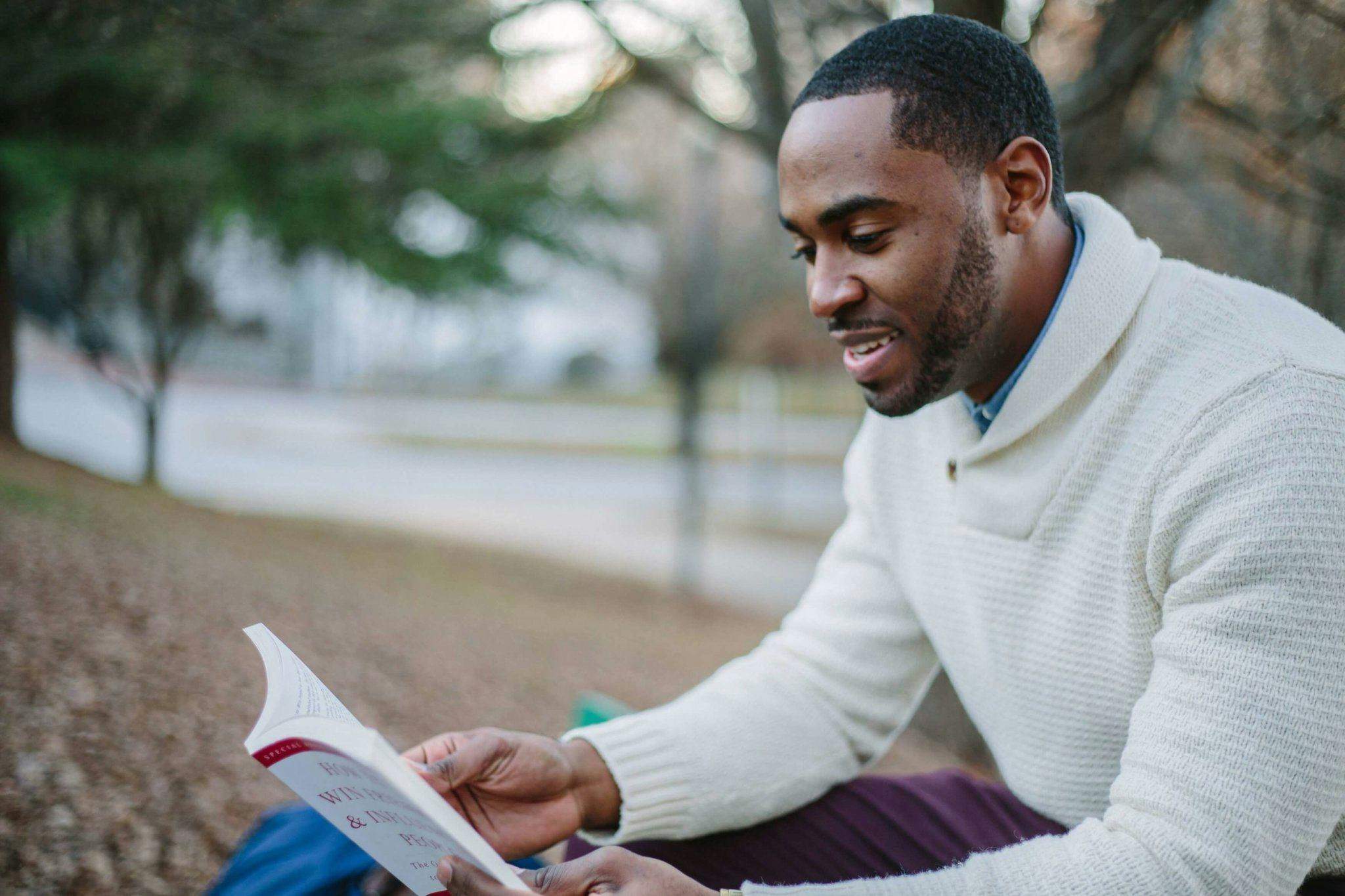 Person reading a book to enhance personal growth and self-reflection.