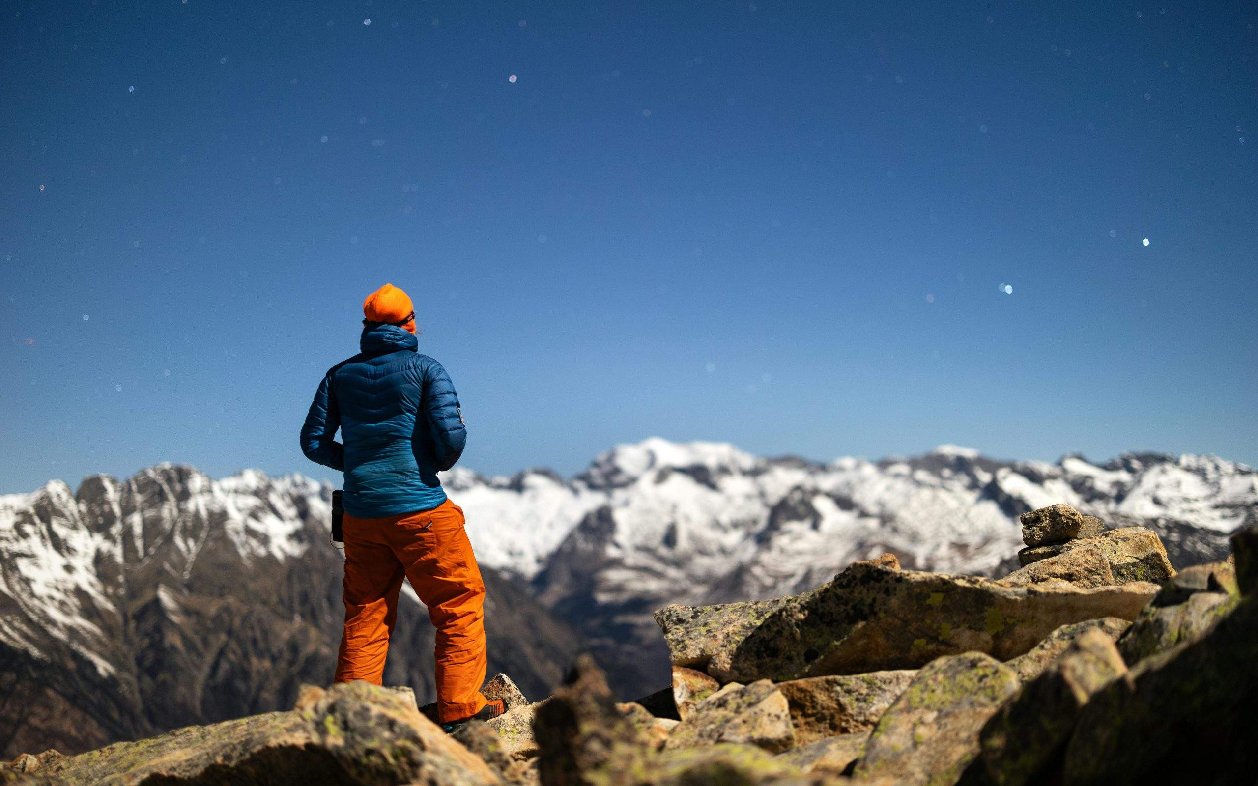 Person on mountain peak symbolizing confidence through self-reflection