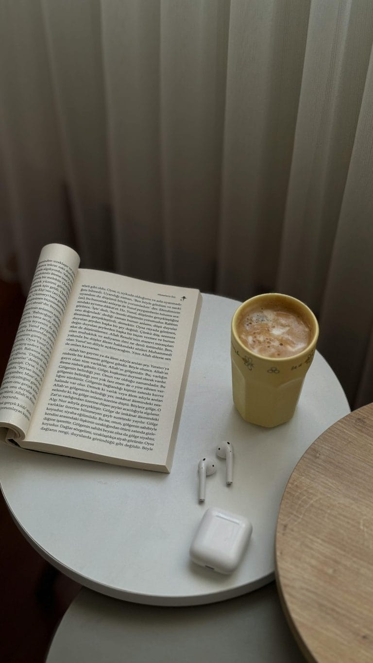 Person writing in a gratitude journal with a calm, focused expression.