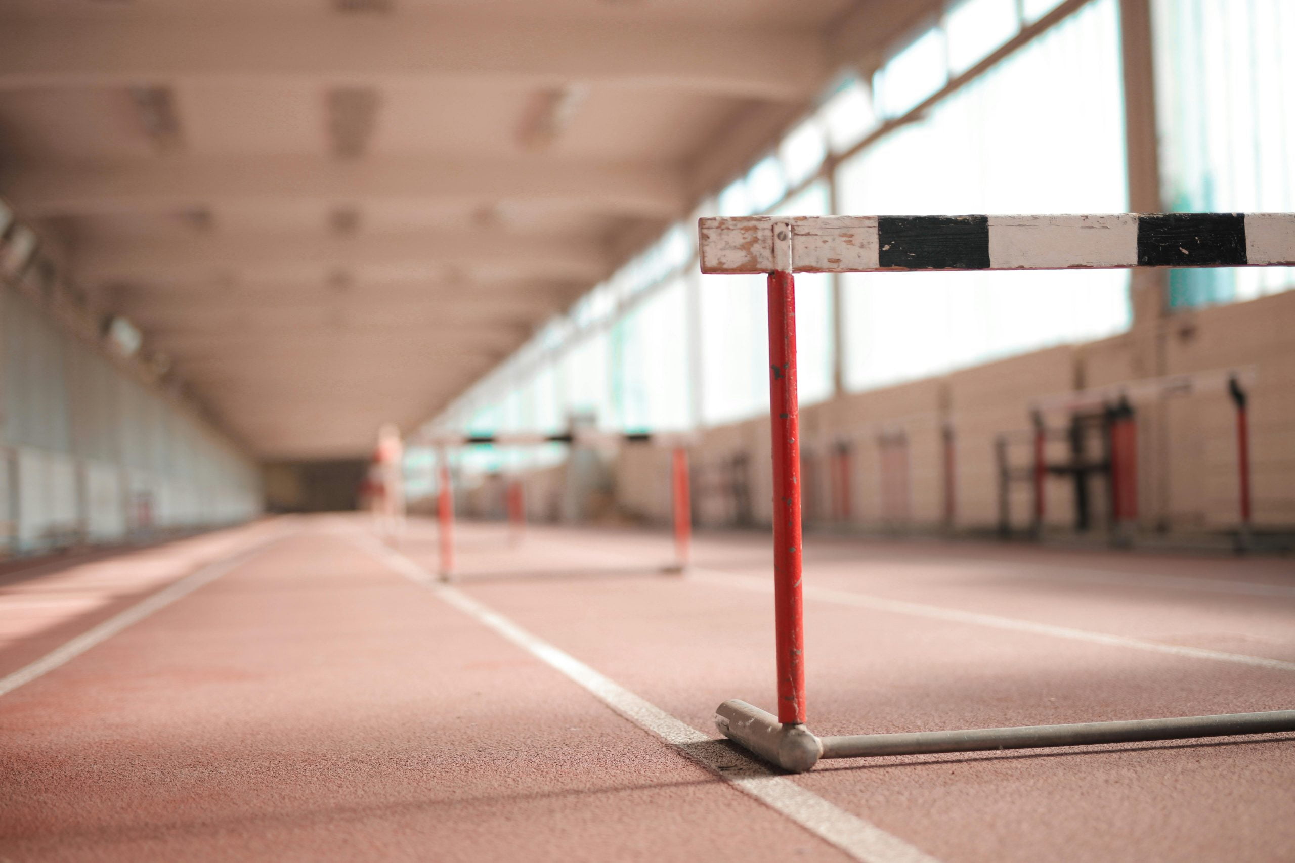 A person overcoming hurdles to symbolize the growth mindset and resilience through failure.