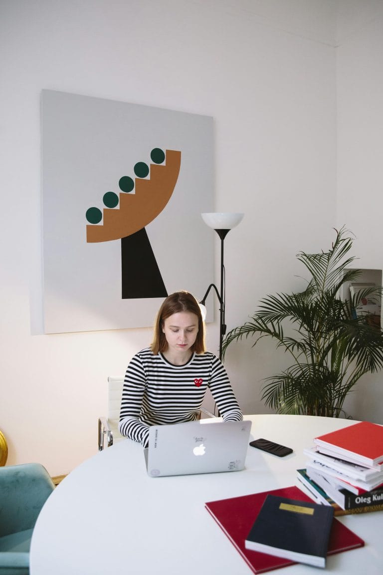 A person studying with books and a laptop, illustrating advanced learning strategies.