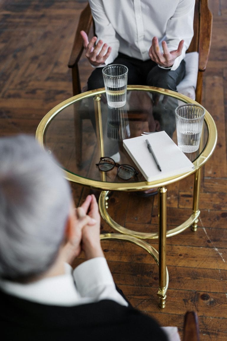 A couple contemplating divorce with a Bible on the table.