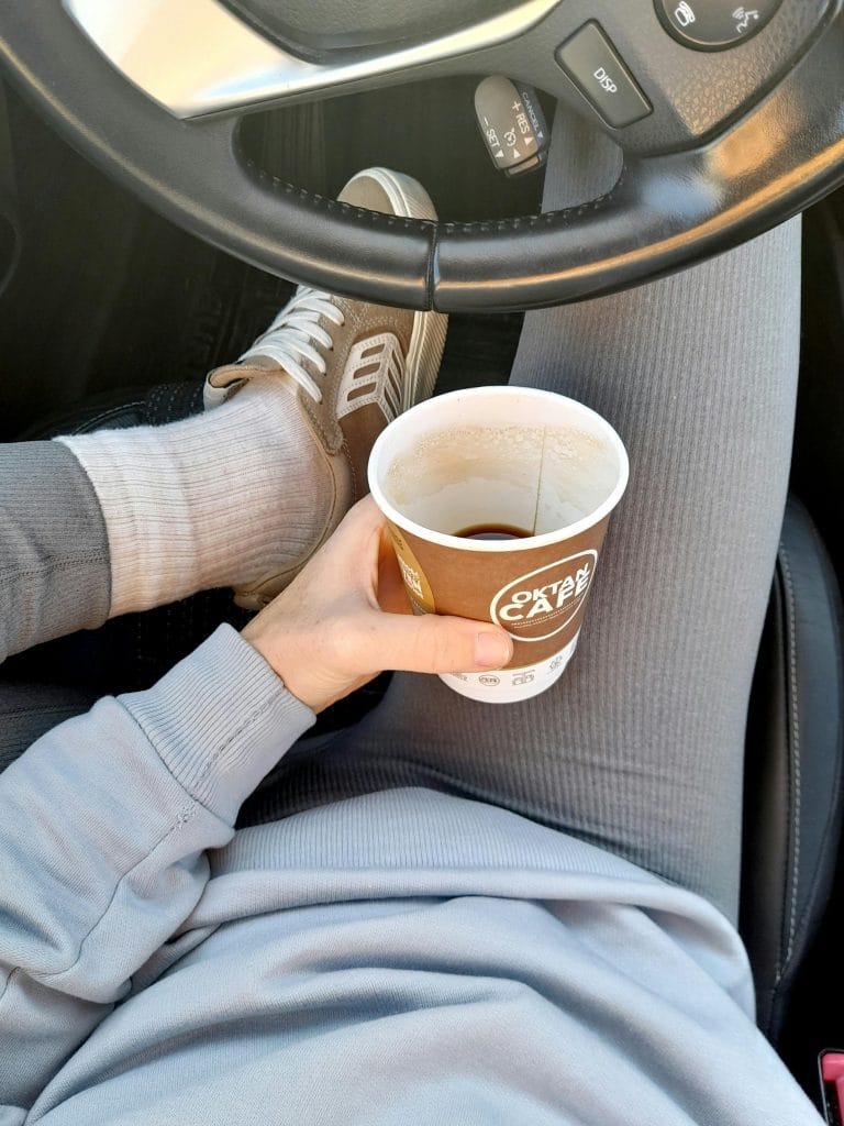 Person tired with a coffee cup, representing coffee addiction and its effects on energy and lifestyle.