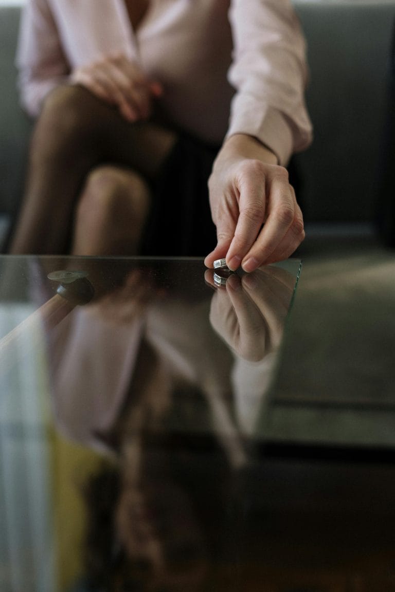 A couple sitting apart on a park bench, contemplating divorce.