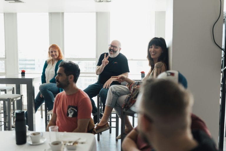 Group of growth-minded people engaging in conversation, representing the impact of peer groups on mindset transformation.