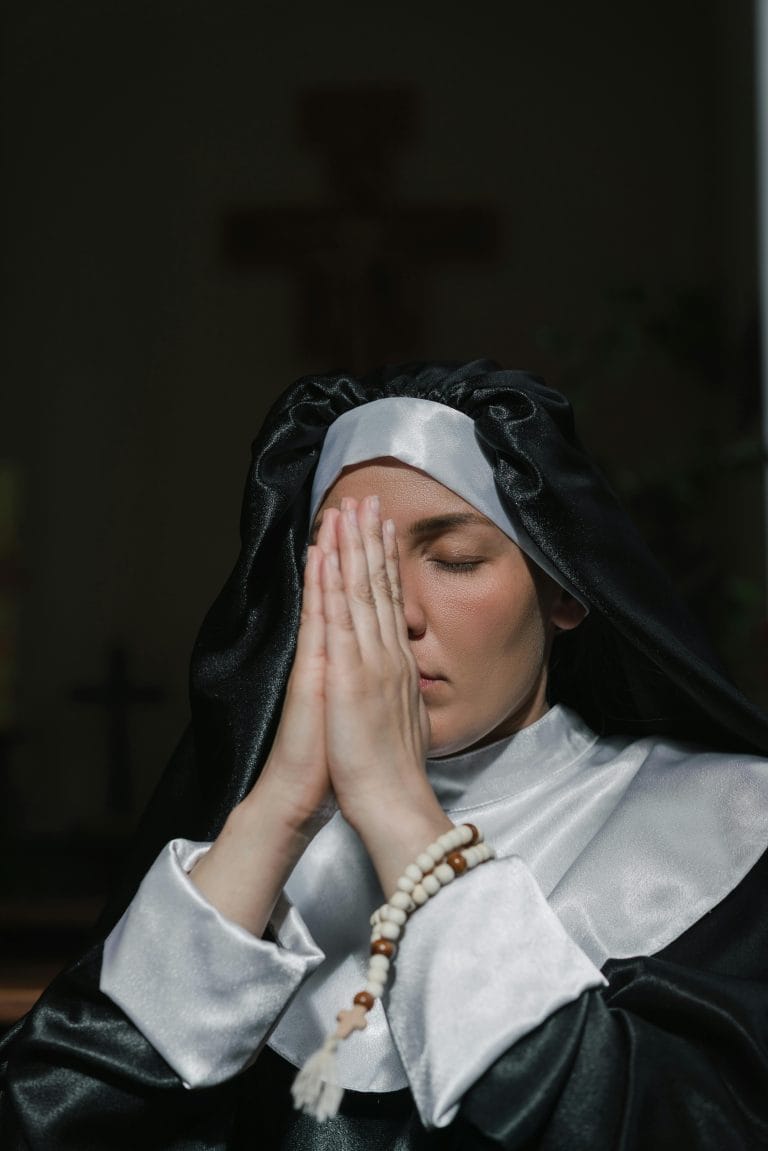 Person praying at sunrise showing the power of habits in religion and success.