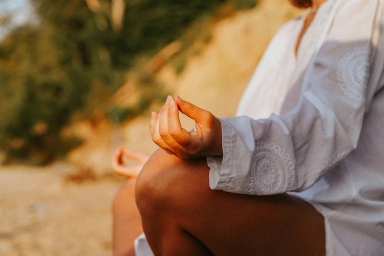 Person meditating outdoors for inner peace and mental resilience