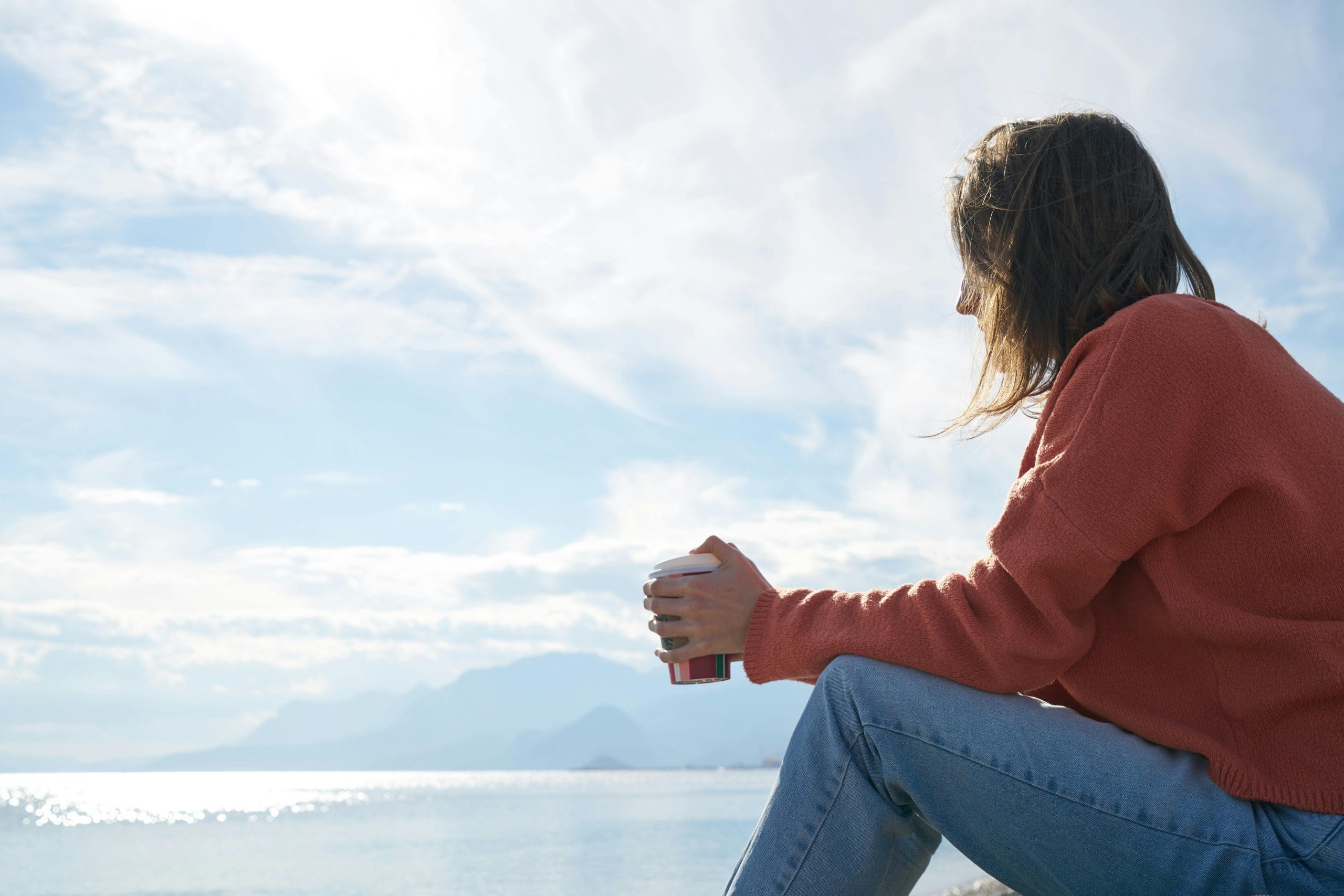 Person sitting alone, reflecting for personal growth and self-discovery