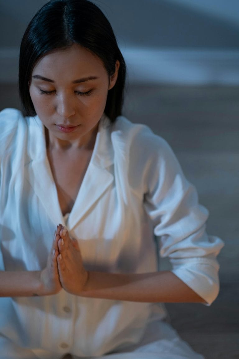 Person in a calm setting practicing self-deliverance prayer for inner peace.