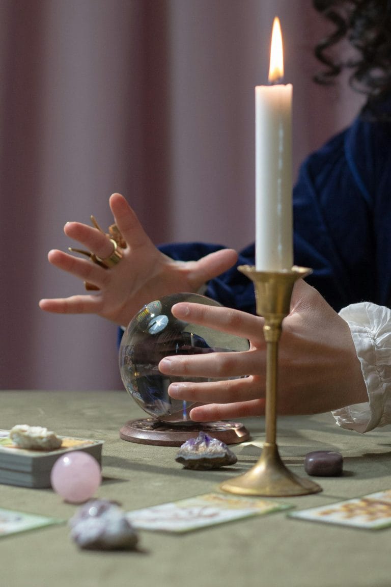 Hands reaching for tarot cards to gain insights for overcoming challenges.