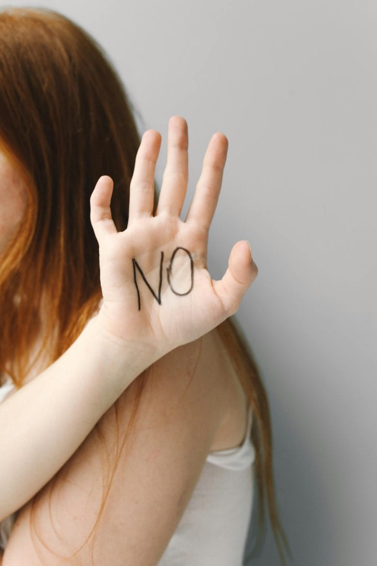 A person confidently saying no with a calendar and clock in the background, symbolizing time management and self-care.