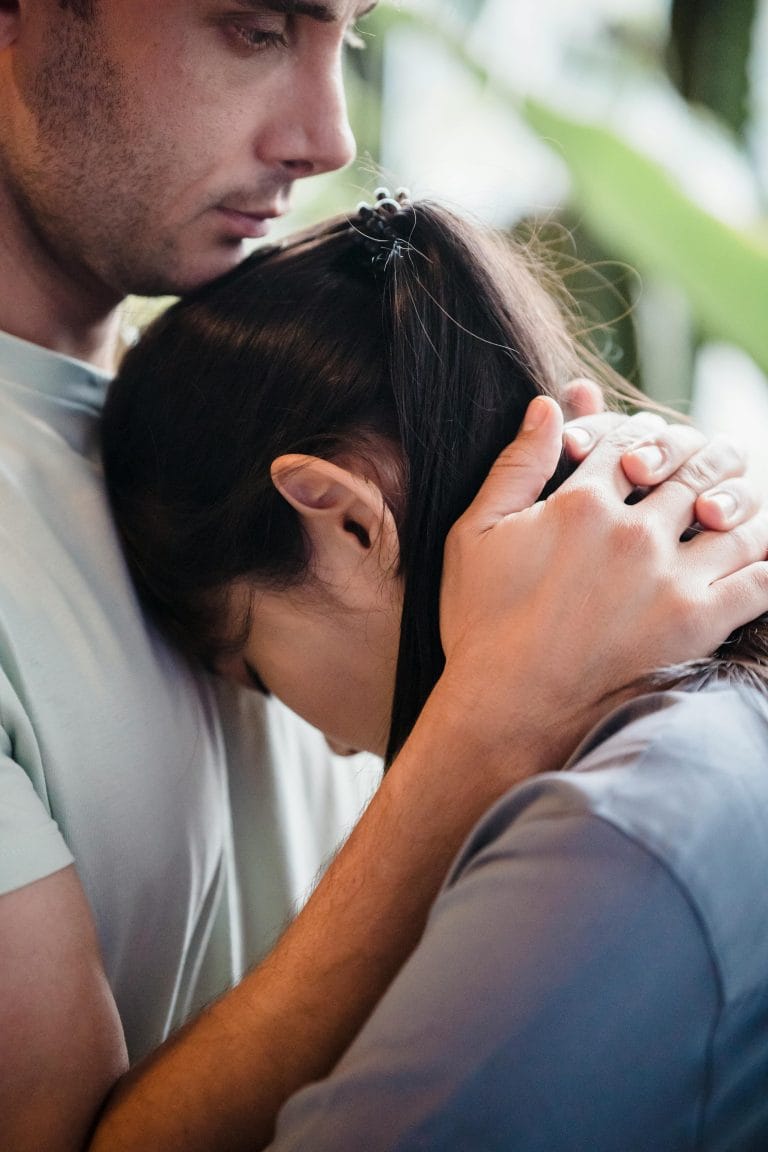 Empathetic woman sharing a moment with a man who has endured abuse