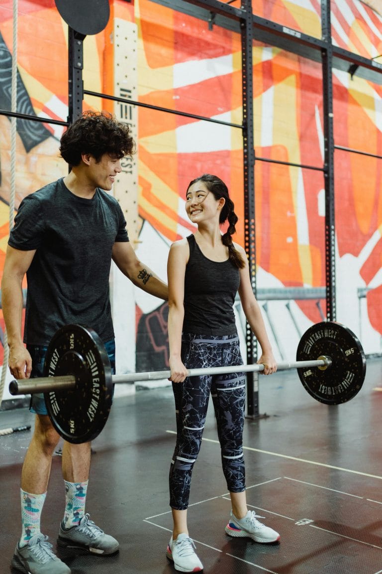 Person lifting weights with motivational affirmations around them