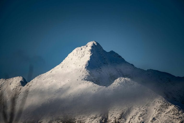 A scenic mountain view symbolizing adventure with an inspiring quote overlay.