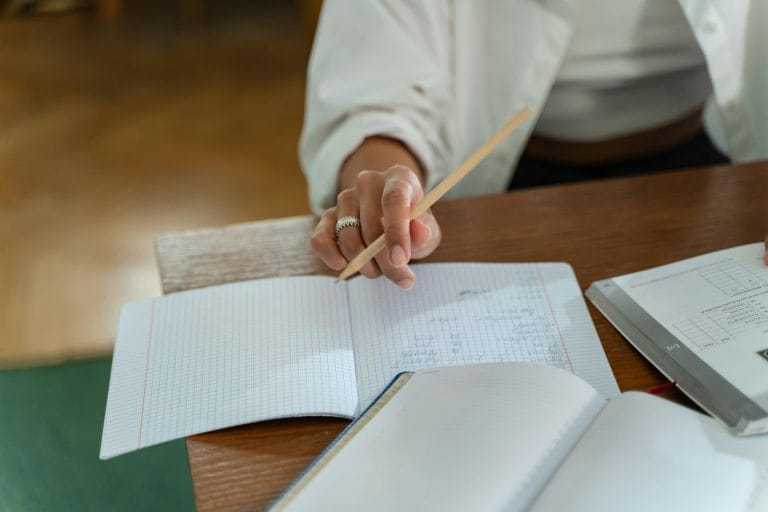 Person writing in a journal, exploring self-discovery and personal growth.