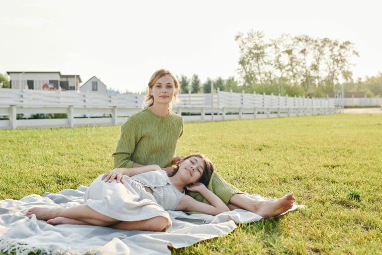 A mother and daughter sitting together, having a supportive conversation.