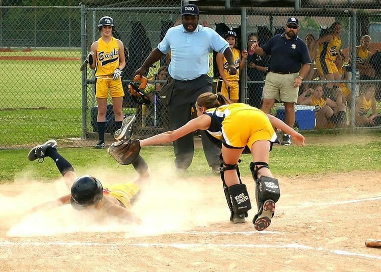 A softball player ready to swing the bat, surrounded by inspiring quotes to boost motivation and performance.