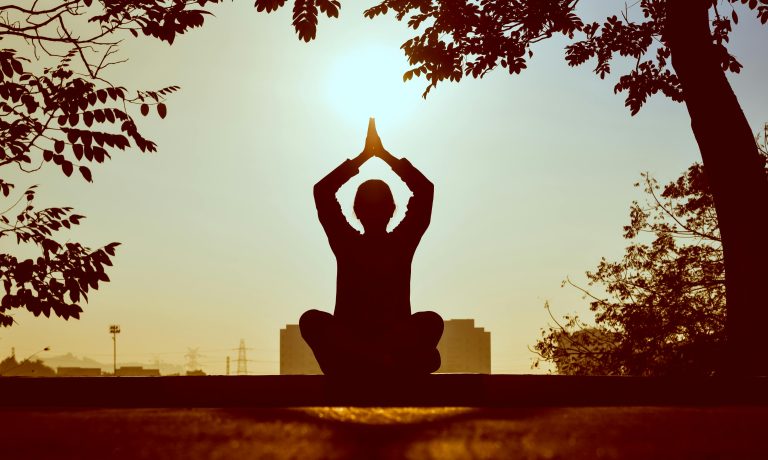 Person journaling in a peaceful environment for self-reflection and emotional wellbeing.