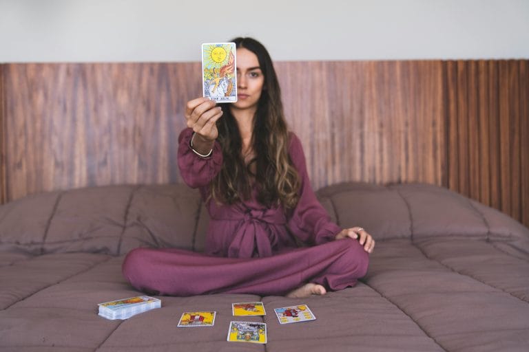 Person discovering life purpose through tarot reading with cards