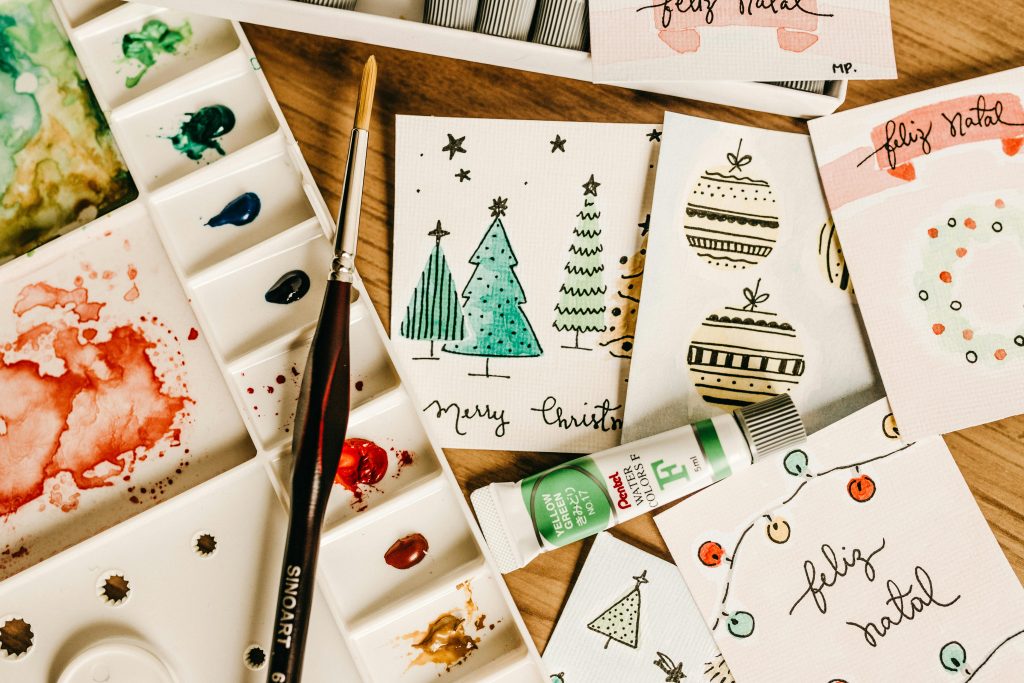 Festive Christmas cards with handwritten messages and decorations.