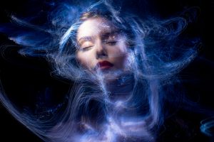 Abstract illustration of a person glowing with energy, surrounded by cosmic light, symbolizing the universe responding to inner being.